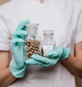 a person holding a bottle of pills