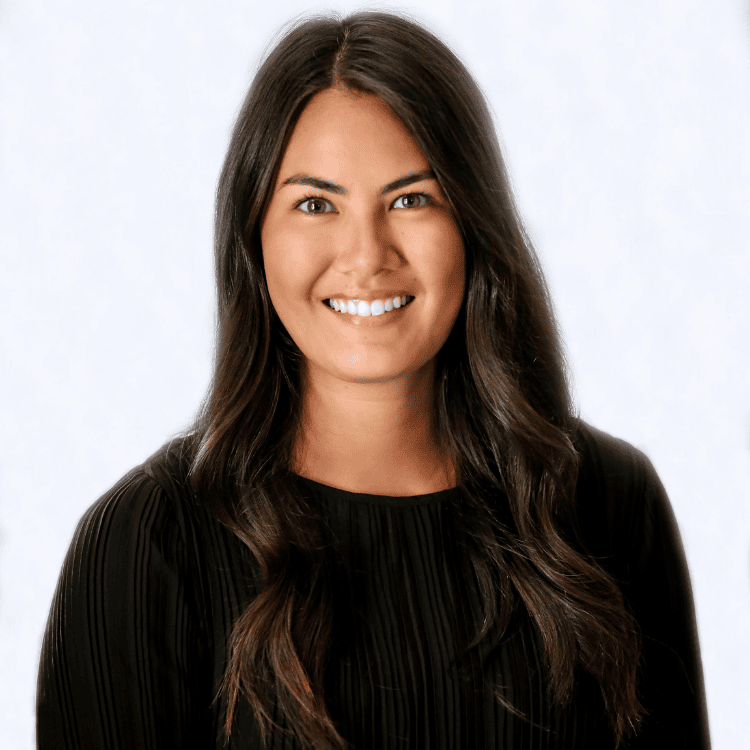 Portrait of a smiling person with long dark hair, wearing a black top, set against a light background, subtly hinting at the story behind ZIPDRIP.