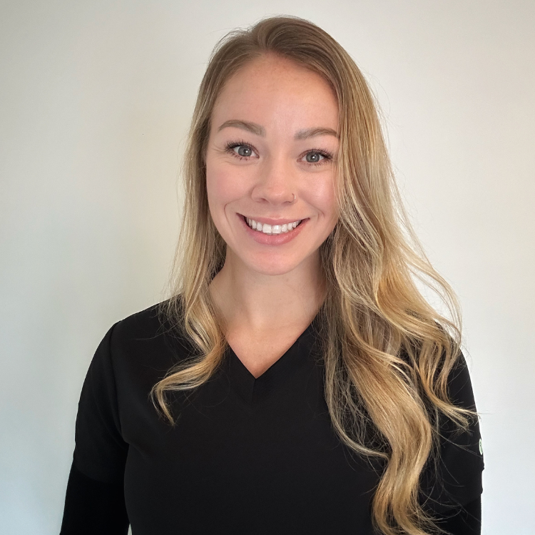 A person with long blonde hair, wearing a black top that perfectly complements the minimalist aesthetic, smiles radiantly against a plain background, reminiscent of the sleek and modern vibe embraced by ZIPDRIP.